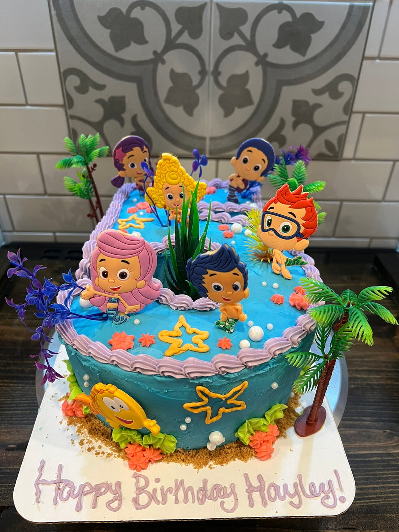 Birthday cake with cartoon character figures on a decorative background